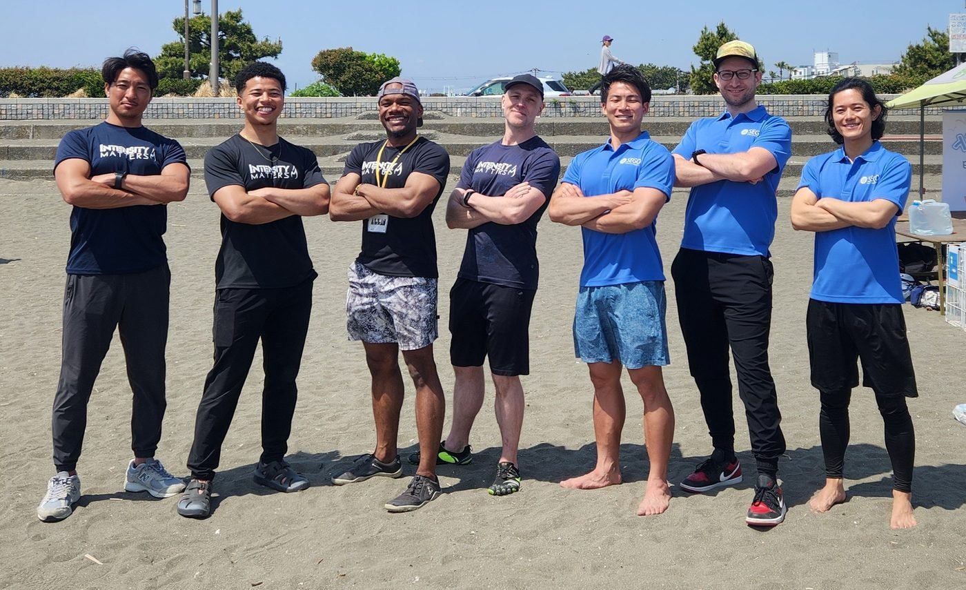 IM and SEGO Initiative crew, arms crossed on the beach